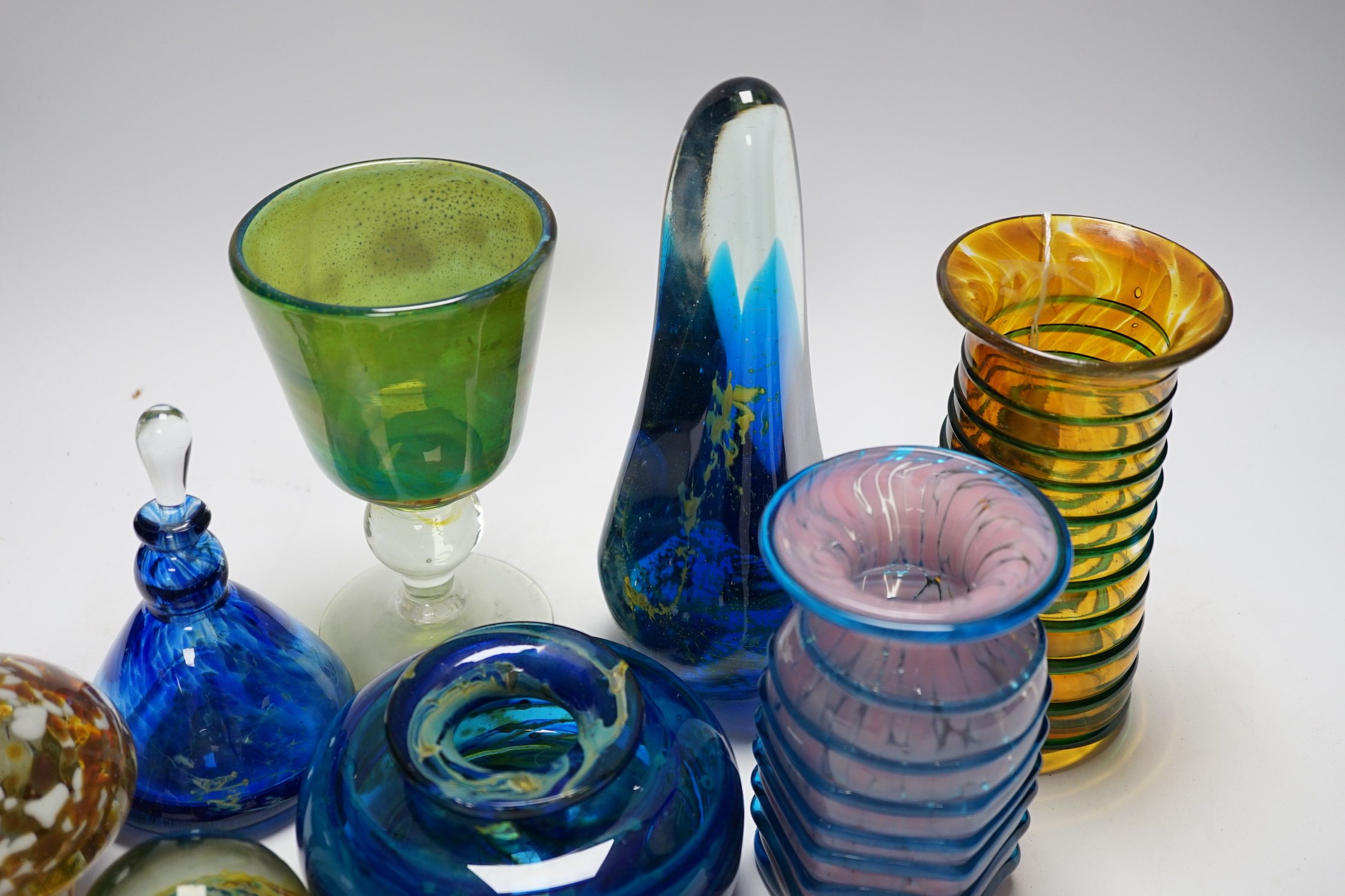 A group of Mdina glass comprising three vases, a stemmed glass, three paper weights and a scent bottle and stopper, (8) tallest 22cms high